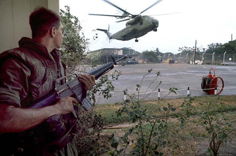 CH-53 helicopter landing and protected by soldier