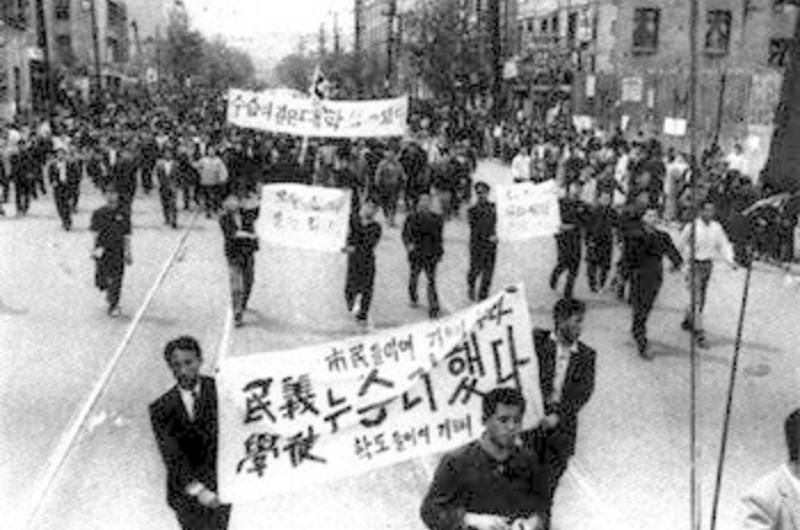 protesters in the street with signs