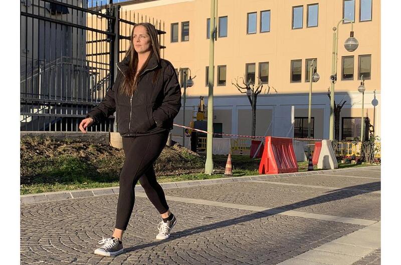 Navy Petty Officer 1st Class Caroline Crumbacker walks at Naval Support Activity Naples, Italy.