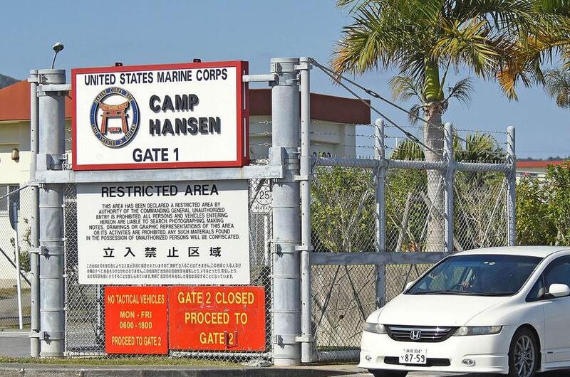A car leaves Camp Hansen, a Marine Corps base on Okinawa, Monday, Dec. 20, 2021.