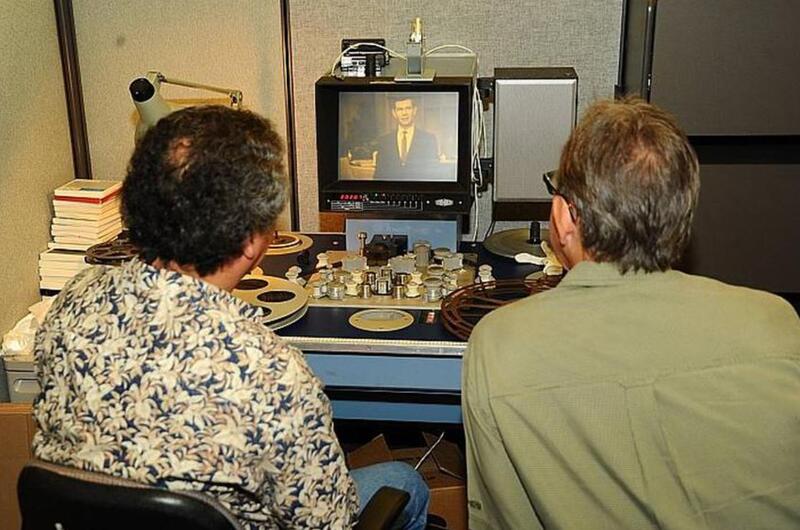 Pedro Loureiro, Ph.D. (left), Archivist at the Defense Imagery Management Operations Center (DIMOC) and Jeff Sotzing, Chief Executive Officer at Carson Entertainment Group, review a 1963 film of The Tonight Show Starring Johnny Carson that was once thought lost, but was found earlier this year. DIMOC turned over the film to Sotzing to be added to the Carson archives.