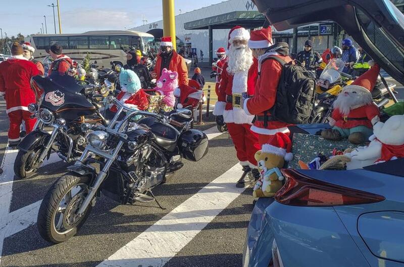 Bikers dressed as Santa gather at a highway rest stop in Ebina, Japan, to deliver hundreds of toys that will be donated to Japanese children's homes, Sunday, Dec. 5, 2021.
