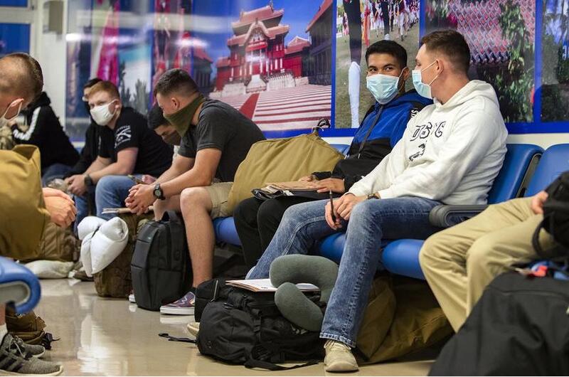 Marines wait inside the passenger terminal at Kadena Air Base, Okinawa, June 6, 2020.