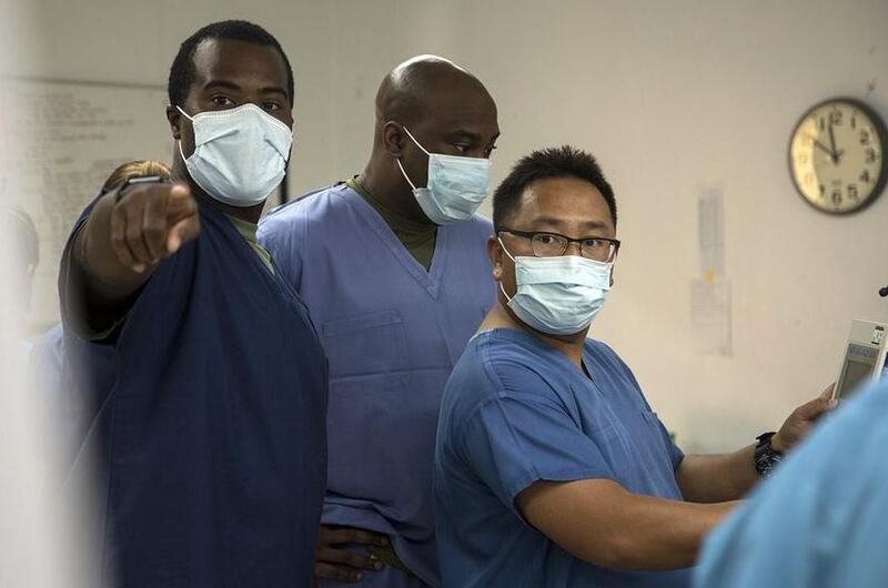 Navy Lt. Rodney Posley, left, an intensive care unit nurse with 3rd Medical Battalion at Camp Foster, Okinawa, trains a pair of hospital corpsmen.