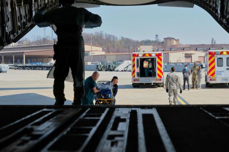 A baby born 10 weeks premature is transferred to a C-17 Globemaster III during a medical evacuation at Osan Air Base, South Korea, Monday, March 30, 2020.
