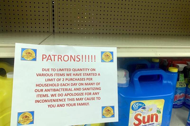 A sign above an empty shelf informs commissary customers at Yokosuka Naval Base, Japan, of purchase limits for antibacterial and sanitation products, Thursday, Feb. 27, 2020.