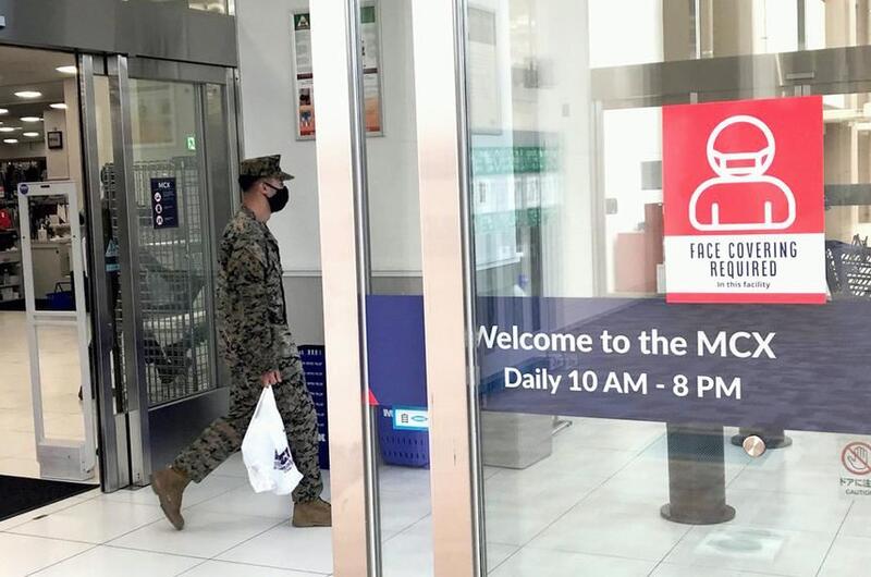 A Marine leaves the exchange at Marine Corps Air Station Iwakuni, Japan, where all patrons are required to wear a mask, Wednesday, Jan. 5, 2022.