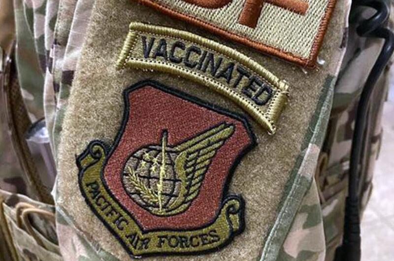 A security forces airman wears a "vaccinated" morale patch in this screenshot from the popular Air Force amn/nco/snco Facebook page.