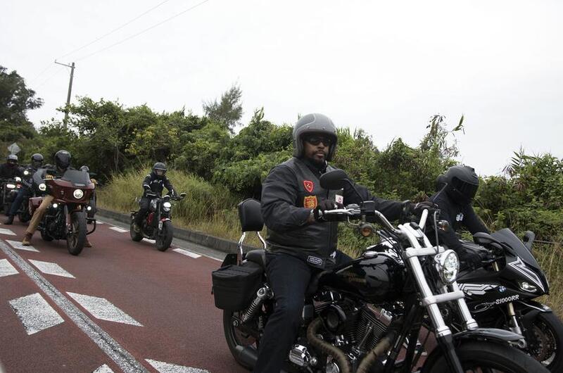 U.S. troops and members of the Okinawa American Legion cruise down Route 58 on their motorcycles.