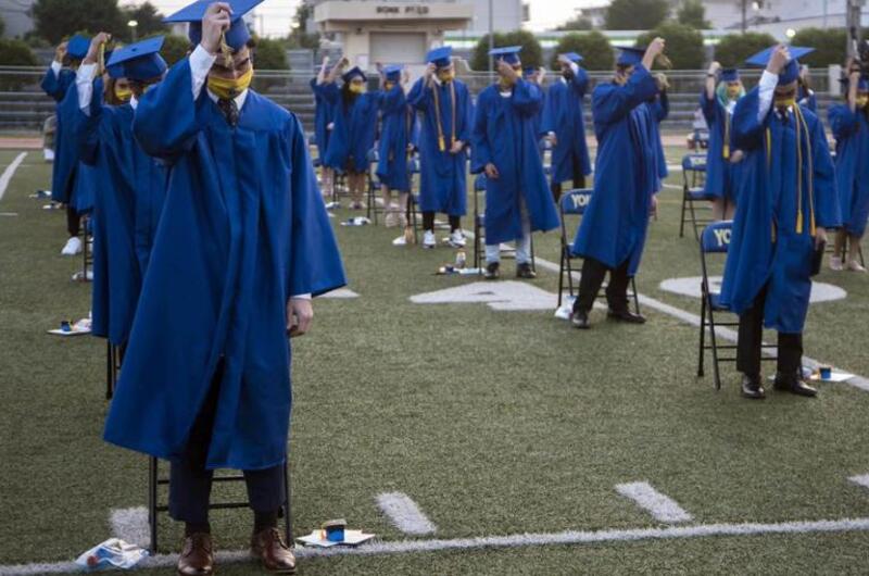 Yokota High School seniors move their tassels during a graduation ceremony at Yokota Air Base, Japan, Thursday, June 4, 2020.