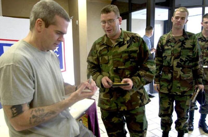 Henry Rollins signs an autograph for Spc. Ed Palmer on Wednesday at the Main Post Club on Yongsan Garrison, South Korea.
