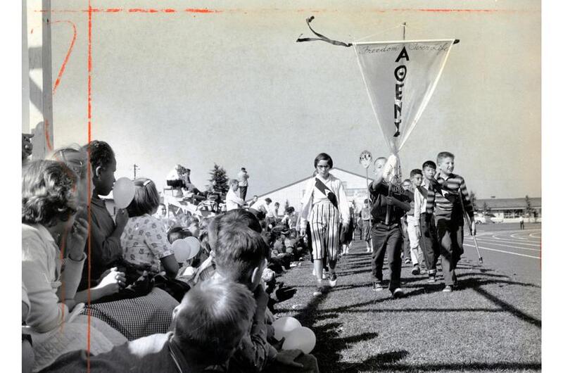 Tachikawa Air Base, Japan, Oct. 22, 1960: Standard of Athens leads Junior Olympic paraders at Tachi West Track at Tachikawa Air Base, Japan, Saturday, Oct. 22, 1960. Behind these athletes are competitors from teams named for Argos, Corinth, Thebes, Sparta and other ancient Greek cities.