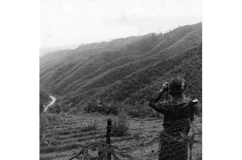 A platoon leader with the 1st Republic of Korea Division looks through a set of binoculars toward North Korea from his position in the Demilitarized Zone. 
