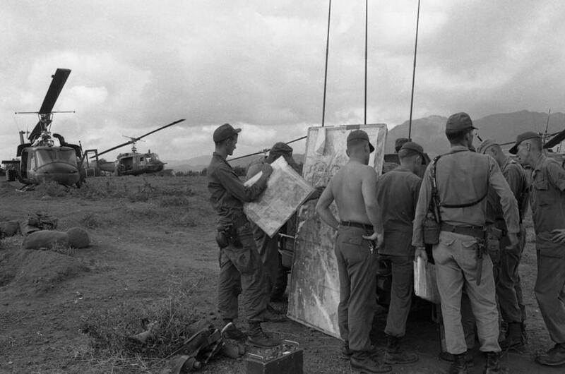 A Scout H-13 helicopter takes off during Operation White Wing at Bong Son. The helos refuel, and pilots get briefed on the operation at the LZ.