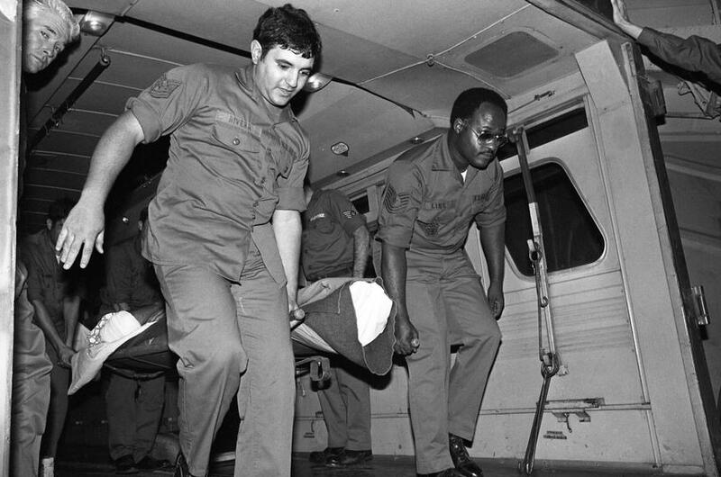 An unidentified burn victim is carried on a stretcher