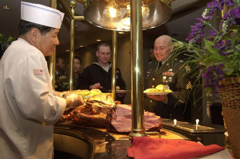 U.S. Army Sgt. Cesar Alvarado, who serves with the United Nations Command’s Military Armistice Commission, waits for a serving of turkey during the USO’s 37th annual “Six Star Salute” on Thursday at Yongsan Garrison, South Korea. Alvarado was one of 80 troops from across the peninsula selected for the two-day program.