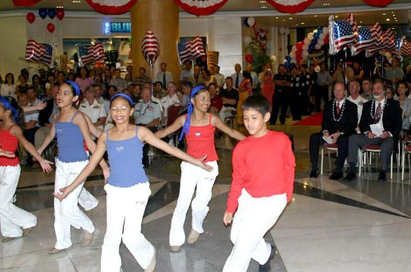 Members of local Guam dance troupe SKIP Entertainment perform during the opening ceremony of the Guam USO location in the Royal Orchid Hotel in Tumon, Guam.