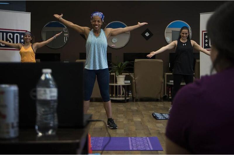 LaDonna Spivey, a personal trainer and volunteer for the USO at Yokota Air Base in western Tokyo, leads a workout via Facebook Live.