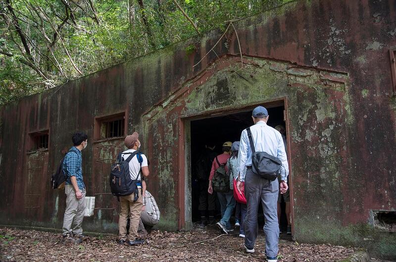 Japanese visitors tour a World War II-era munitions storage site at Tama Hills Recreation Area in western Tokyo, Wednesday, May 26, 2021.