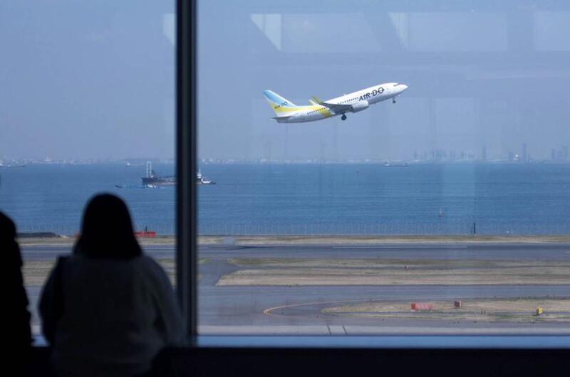 A flight takes off from Haneda International Airport in Tokyo, March 18, 2020.