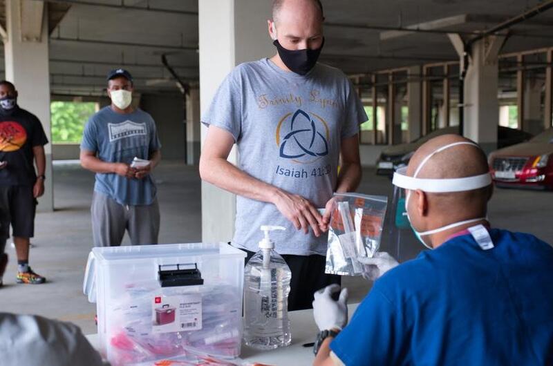 A service member receives a coronavirus test kit within hours of arriving at Osan Air Base, South Korea, Tuesday, July 14, 2020.