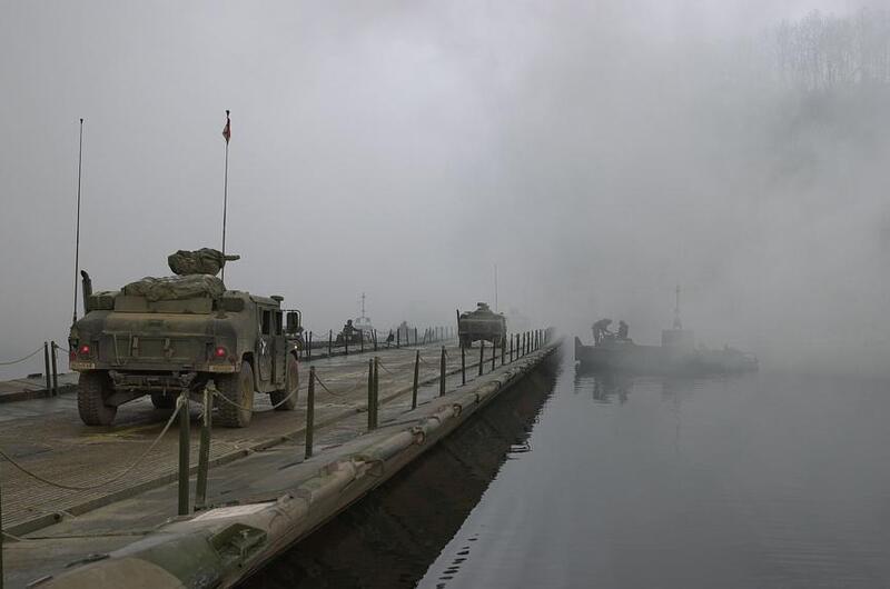 Military vehicles cross the Imjin River