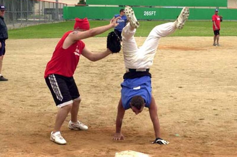 A Warriors player crosses home plate doing a handstand during last week’s successful attempt by members of the 2nd Infantry Division to break the world record for longest continuous softball game. The game lasted 100 hours and ended Saturday.