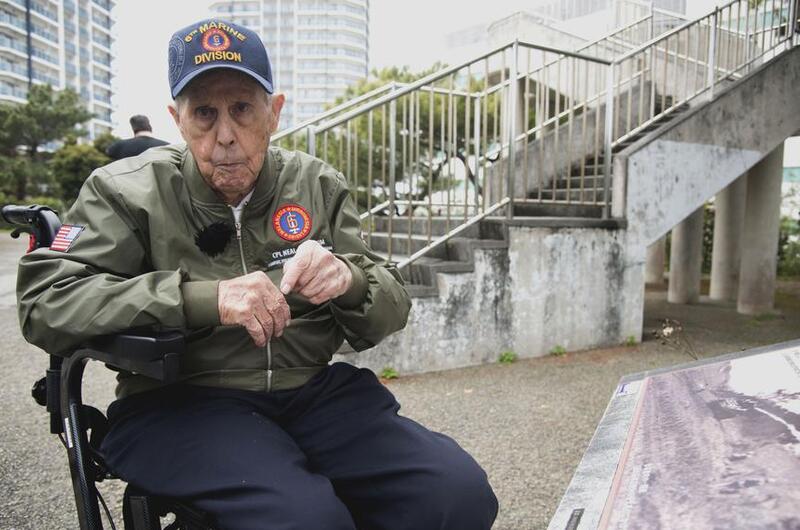 A Marine Corps veteran sitting in a wheelchair speaks about his wartime experiences. 