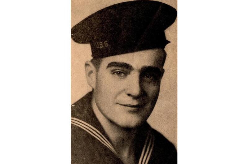 A sepia-toned photo of a U.S. Navy sailor in uniform from around the 1940s.