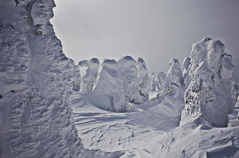 A barren landscape of what looks like snowy hills. 