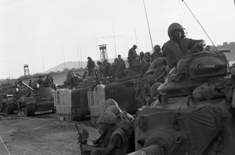 The 1st Battalion, 1st Regiment, 1st Marine Division moves to take up a position on the south side of Go Noi Island supported by Marine tanks and Landing Vehicles Tanks (LVTs).