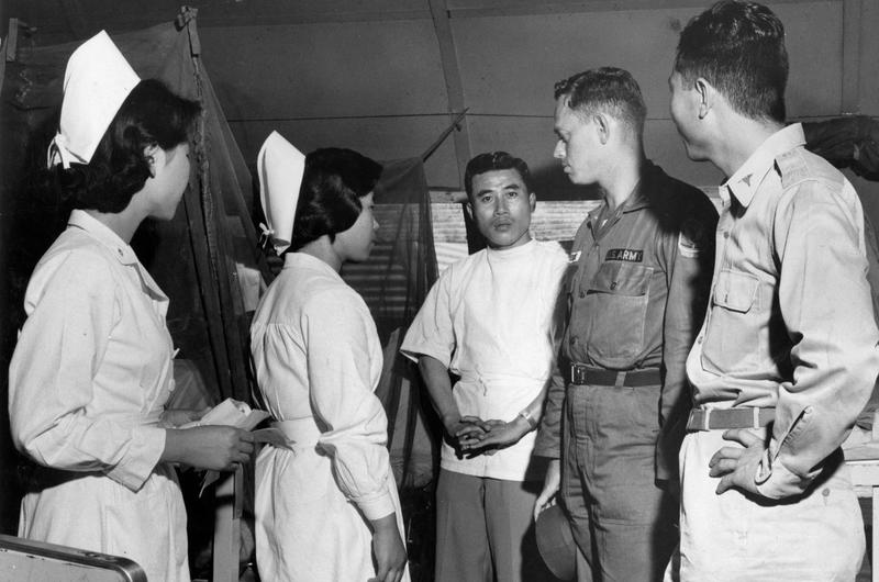 Dr. (Captain) Vernon J. Hendrix talks to the doctors and nurses at the 77th Army Hospital near Kwangju. He knows the medical problems in his area through trips he has made to six provincial hospitals not too far from Sang Mu Dae, where he is attached as the medical officer of Detachment K, U.S. Army Advisory Group, South Korea.