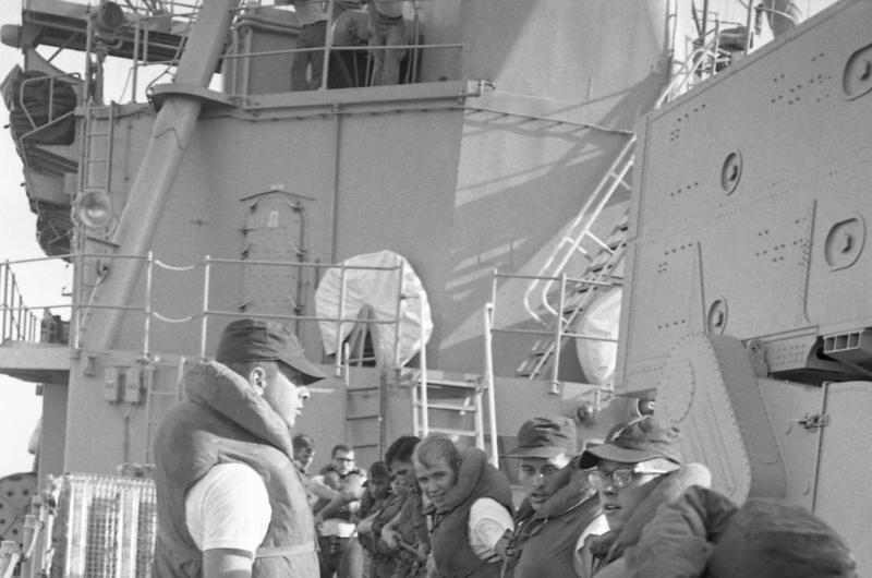 Sailors pull rope during the refueling and rearming operation on board the USS Buchanan destroyer by the tanker USS Tappahannock  [not visible].