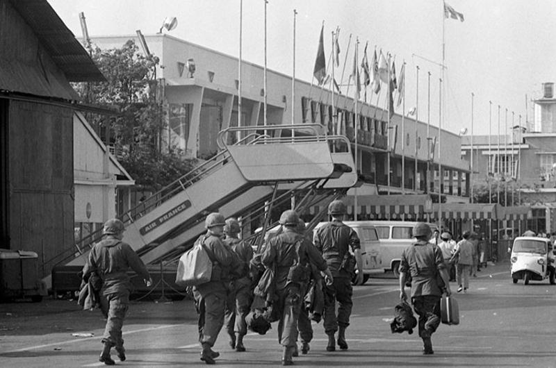 Fresh troops walk down the tarmac in Vietnam after having disembarked from the airplane. They are members of the 6th Battalion, 31st Infantry, 9th Infantry Division.