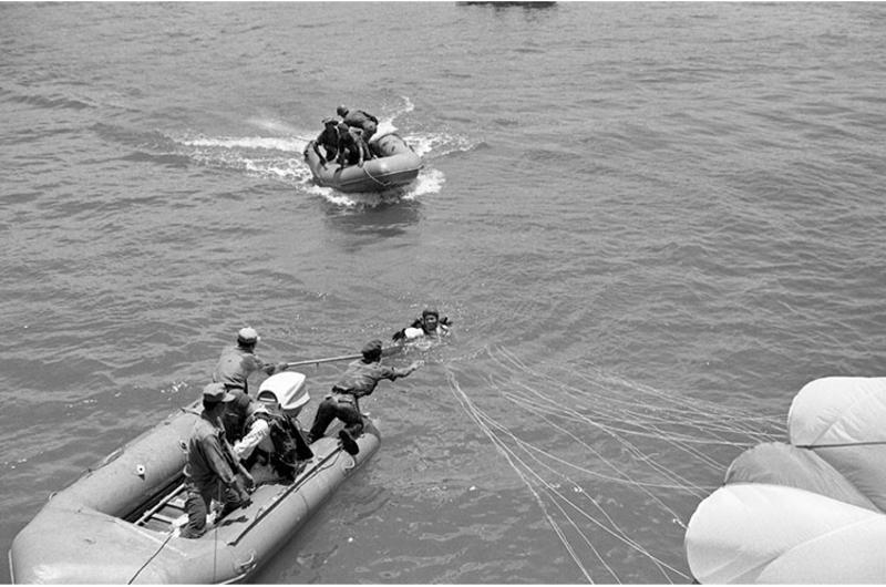 An Army of the Republic of Vietnam (ARVN) paratrooper is ready to get pulled aboard by Republic of Vietnam Navy after landing in Da Nang river.