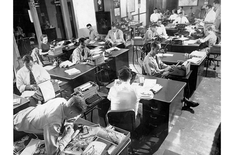 Stars and Stripes Pacific reporters and editors are working hard to get copy ready in time for the next print deadline in the newsroom at the paper's Hardy Barracks offices.