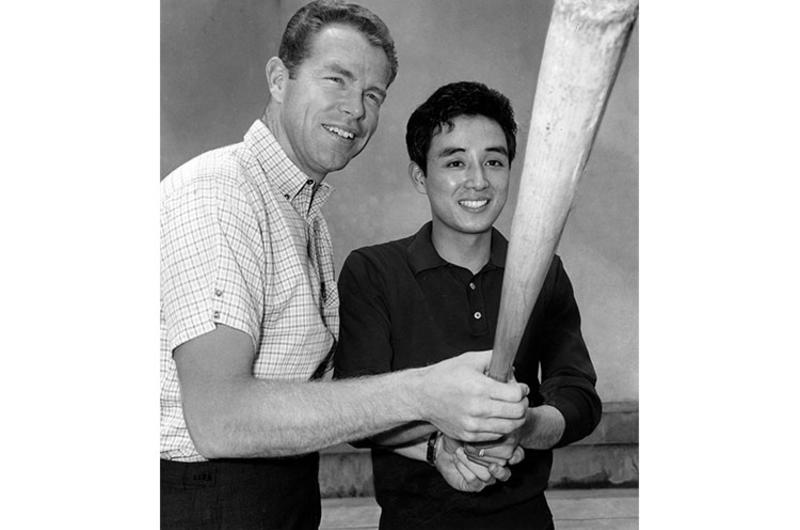 Mitsunaka Saito, Pacific Stars and Stripes copy boy, gets a batting tip from Gordy Windhorn, outfielder for the Hankyu Braves of Japan's Pacific League.