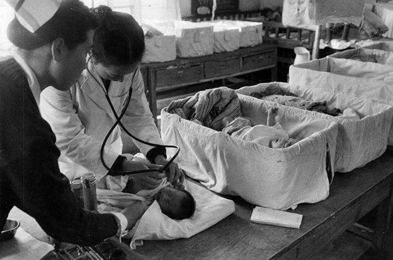 Dr. Wong Ok Ja examines one of the many babies in a ward located in the old section of the hospital.