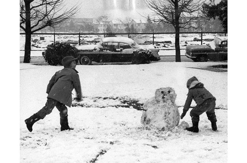 Children in Tokyo's Washington Heights Dependent Housing Area get in some old-fashioned snow fun as the first real snow of the winter fell in Tokyo Sunday.