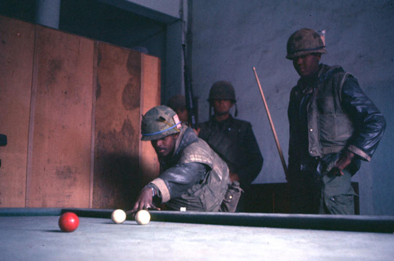 U.S. Marines take advantage of a lull in fighting to play some billiards on a billiards table found inside a building in Hue city.