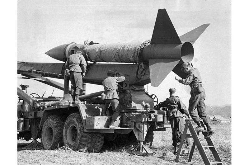 Honest John Rocket is prepared for firing by men of D Battery, 1st Field Artillery Battalion, 31st Artillery Regiment of the 7th U.S. Infantry Division, at Camp St. Barbara, Korea.
