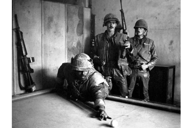 During the lengthy battle for control of the old Vietnamese national capital city of Hue, weary U.S. Marines manage to find a few minutes to relax.
