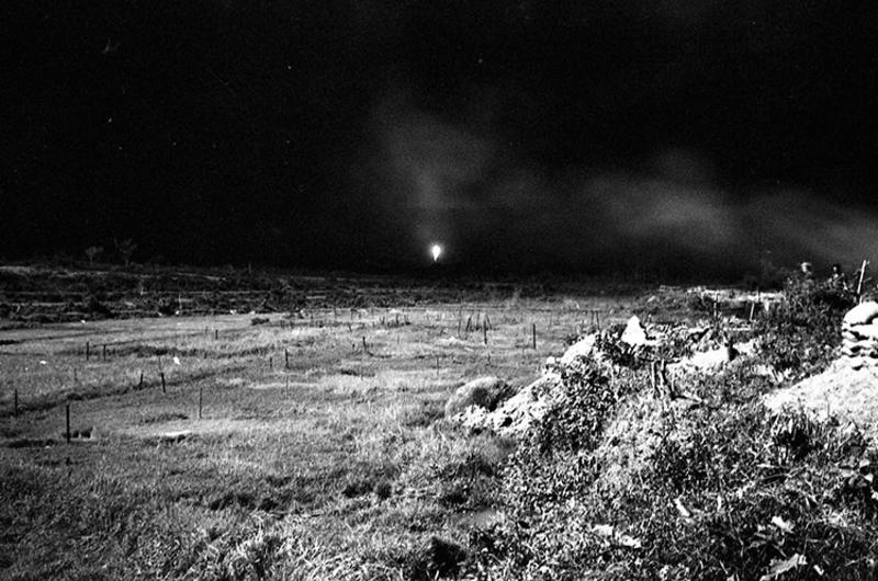 Illumination rounds fall outside perimeter at LZ Ross as tracers, fired during "mad minute", are fired in all directions.
