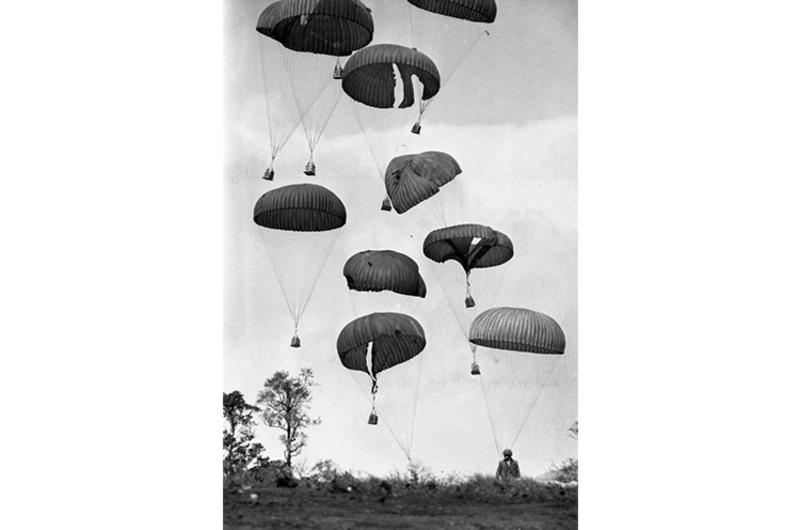 Supplies dropped out of an Air Force C-130 cargo plane pummel to the ground in the drop zone at Khe Sanh.