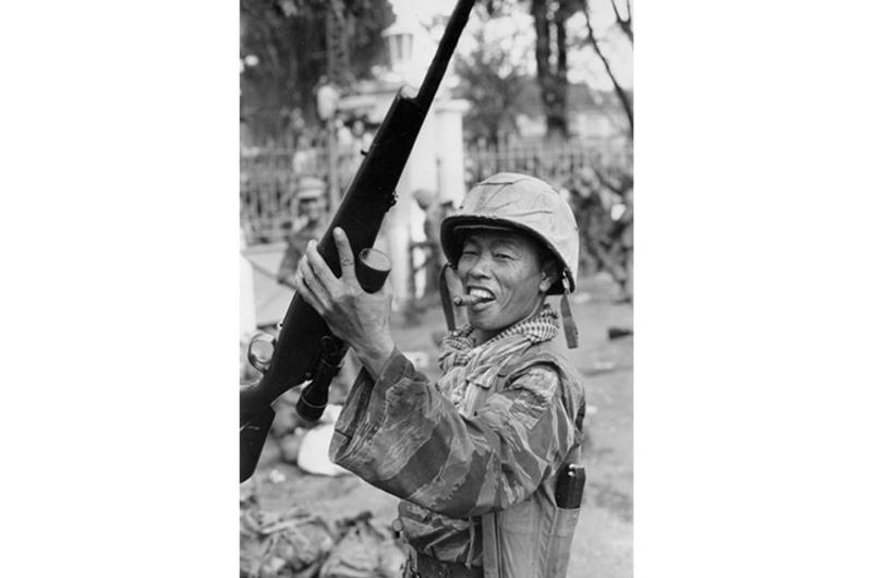 A Vietnam Marine holds a coup trophy, Nov. 1, 1963. Vietnam Marine celebrates on the streets of Saigon after the successful coup deposing president Ngo Dinh Diem November 1, 1963.
