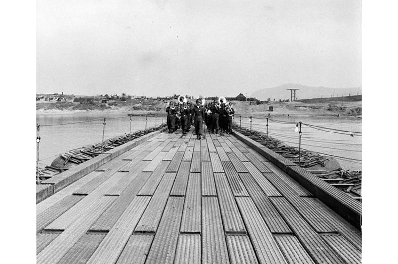 The marching band of the Republic of Korea Army parades proudly across the new bridge at ceremonies on the day it was officially opened.