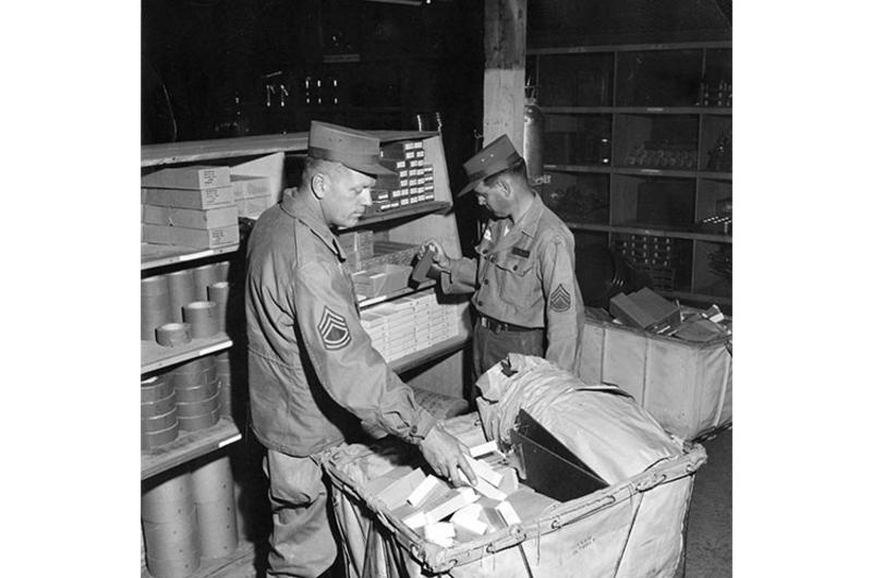 SERVING THEMSELVES are SFC Richard J. Kingston (left) and Sgt. Lewis F. Jones, both "shopping" for their units at the new Quartermaster Self-Service Supply Center that opened at Yongdong-po recently.