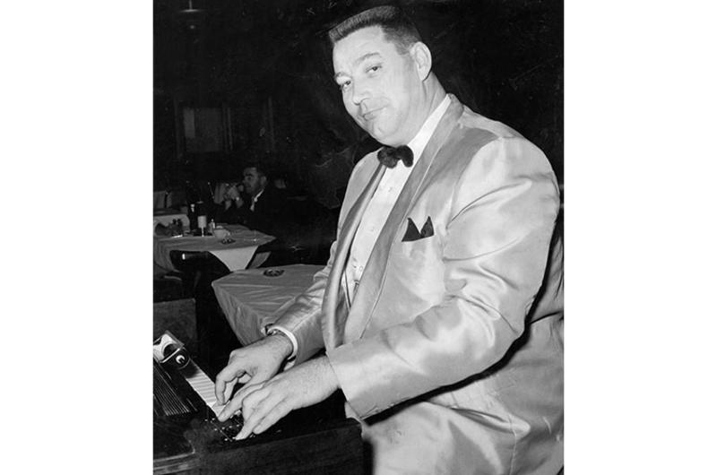 Big Bob Burnham, who tips the scales at 295 pounds. Big Bob Burnham plays the baby Hammond organ at the Top Three Club in Sukiran five nights a week, filling the time between band performances with music and comedy routines.
