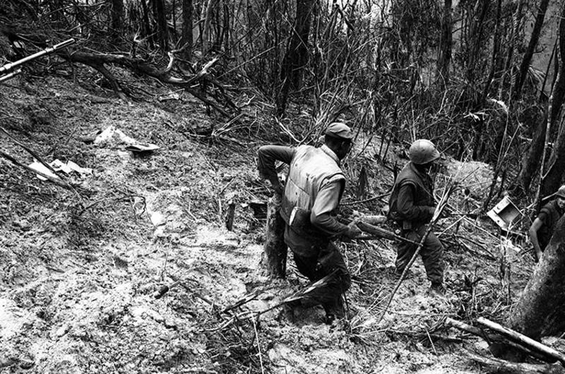 Members of Mike Co. move through rough jungle terrain on the way to Hill 484.