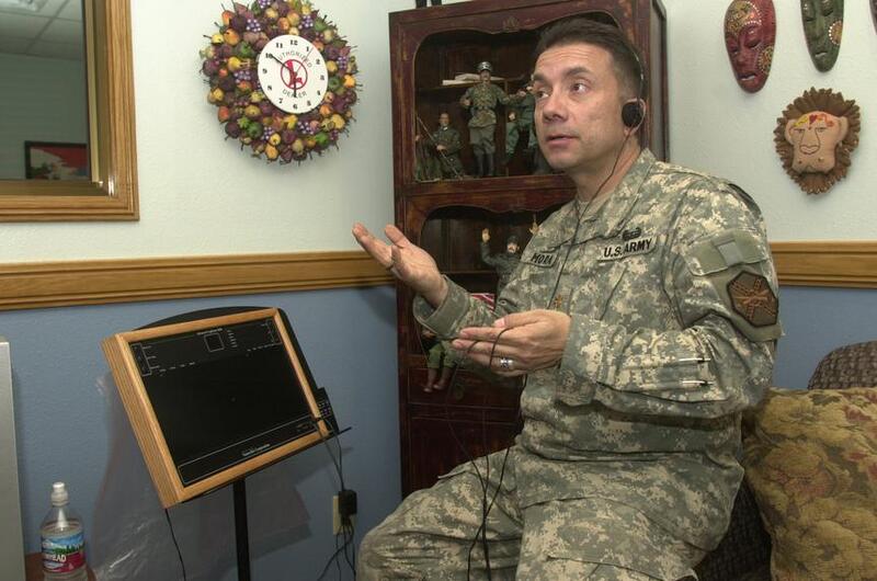 A chaplain demonstrates a therapy board.